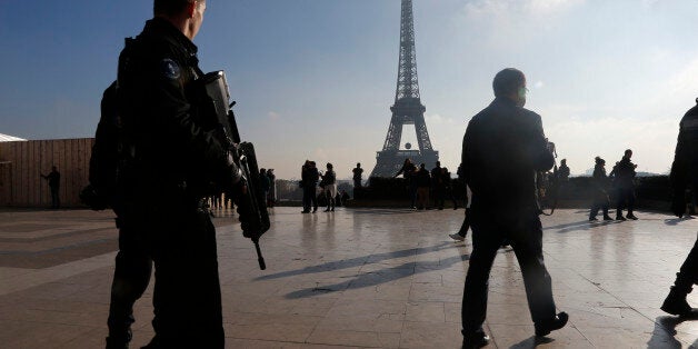 French police officers patrol near the Eiffel Tower, in Paris, Monday Nov. 23, 2015. French President Francois Hollande will preside over a national ceremony on Nov. 27 honoring the at least 130 victims of the deadliest attacks on France in decades. (AP Photo/Jacques Brinon)