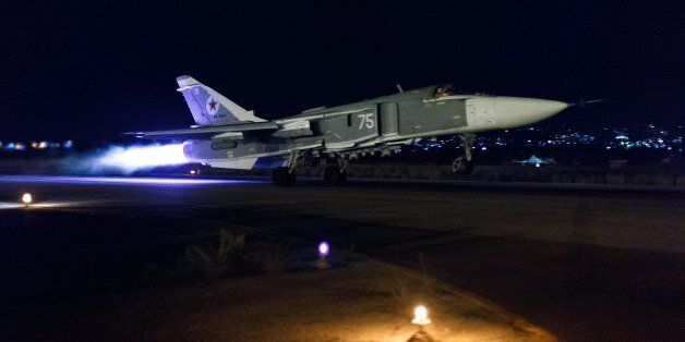 This handout photo released by the Russian Defense Ministry official web site shows a Russian Su-24 bomber taking off on a night combat mission from Hemeimeem airbase in Syria, late Thursday, Oct. 22, 2015. Russian jets regularly hit targets at night, a capability the Russian air force lacked until recently. (Vadim Savitsky/Russian Defense Ministry Press Service via AP)