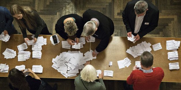 Counting the votes at Aarhus City Hall, in Corpehagen, Thursday, Dec. 3, 2015. Danes voted Thursday in a referendum to decide whether the Danish opt-out on EU Justice and Home Affairs should be replaced by an opt-in model. (Christian Klindt Soelbeck/Polfoto via AP) DENMARK OUT