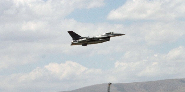 A Turkish F-16 prepares to taxi while another one takes off during Anatolian Eagle exercise at 3rd Main Jet Air Base near the central Anatolian city of Konya, Turkey, Monday, June 15, 2009. Dozens of U.S., British and Turkish pilots are engaging in mock aerial battles over central Turkey, indicating deepening relations between the allies. Pilots from Jordan and the United Arab Emirates are also participating in the exercise. (AP Photo/Selcan Hacaoglu)