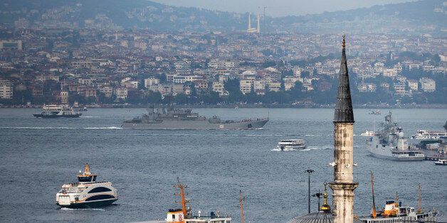 A Russian warship passes through the Bosphorus, in Istanbul, en route to the Mediterranean Sea, Tuesday, Oct. 6, 2015. Russia began launching military operations in Syria on Wednesday, targeting mainly central and northwestern Syria, strategic regions that are the gateway to its long-term ally President Bashar Assad's main strongholds. (AP Photo)