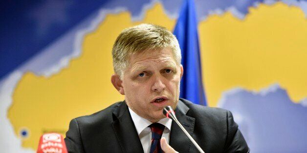 Slovakian Prime Minister Robert Fico talks to the media after the emergency EU heads of state summit on the migrant crisis at the EU council building in Brussels on early Thursday, Sept. 24, 2015. European Union leaders, faced with a staggering migration crisis and deep divisions over how to tackle it, managed to agree early Thursday to send 1 billion euros ($1.1 billion) to international agencies helping refugees at camps near their home countries. (AP Photo/Martin Meissner)