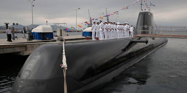 Greek Navy officers of Pipinos submarine stand during a launch ceremony at Skaramanga shipyards near Athens, on Monday, Oct. 6, 2014. Greece launched the submarine Pipinos Monday, the first of three German-designed Type 214 submarines featuring an air-independent propulsion system. Its construction followed years of delays due to legal and technical disputes. (AP Photo/Petros Giannakouris)