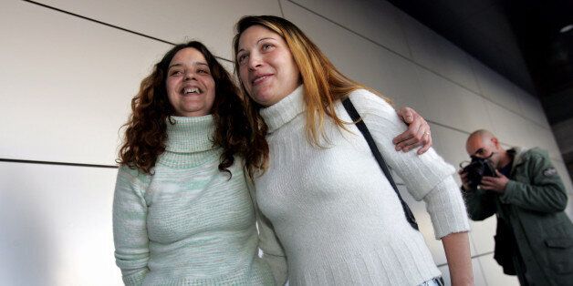 Helena Paixao, right, 35, and Teresa Pires, 28, who have been together for over three years, leave a registry office after requesting a marriage license Wednesday, Feb. 1 2006, in Lisbon. The two women are the first gay couple to mount a public challenge to marriage laws in Portugal where same-sex marriage is not allowed. (AP Photo/Gustavo Bom)