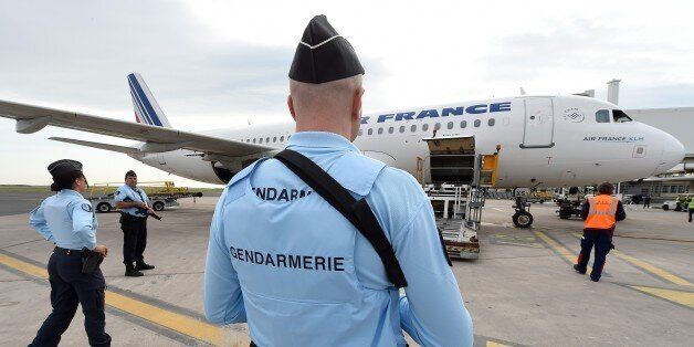 French Gendarmes stand guard at the airport of Montpellier, southern France, on November 20, 2015. The European Union agreed on November 20 to rush through reforms to the passport-free Schengen zone by the end of the year amid growing concerns about border security in the wake of the Paris attacks. The November 13 Paris attacks left 130 people dead and over 350 injured. The placard at left reads 'State of Emergency'. AFP PHOTO / PASCAL GUYOT (Photo credit should read PASCAL GUYOT/AFP/Getty Images)