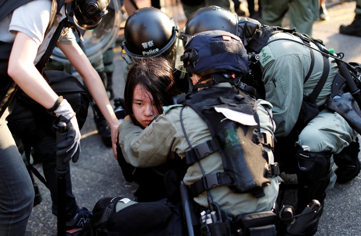 An anti-government protester is detained during a march in Tuen Mun, Hong Kong Sept. 21, 2019.