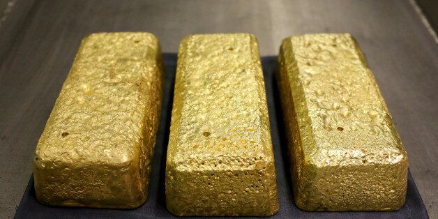Three gold bars each weighing 25 kilogrammes sit on display at the Verninsky GOK gold mine and processing plant, operated by Polyus Gold International Ltd., near Bodaybo, Russia, on Wednesday, Sept. 23, 2015. Polyus Gold International is Russia's largest gold producer and one of the top 10 gold miners globally by ounces produced. Photographer: Andrey Rudakov/Bloomberg via Getty Images
