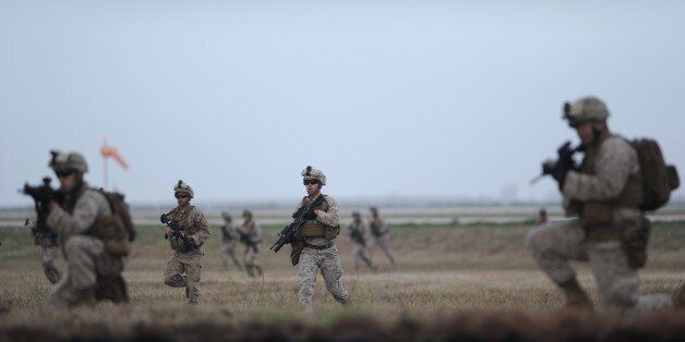 US marines perform a demonstration during the visit of US Secretary of Defense and Spanish Defence Minister to the US marines base in Moron de la Frontera October 6, 2015. Carter's is on a five day European trip aimed at thanking allies from the US-led coalition that is carrying out daily drone and plane strikes against IS in Iraq and Syria. Spain has agreed to the establishment of a permanent force of 2,200 US marines to intervene in Africa, at Moron de la Frontera site. AFP PHOTO / CRISTINA QUICLER (Photo credit should read CRISTINA QUICLER/AFP/Getty Images)