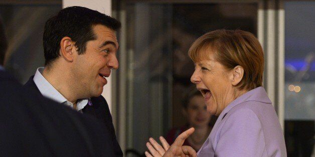 Germany's Chancellor Angela Merkel (R) talks to Greece's Prime minister Alexis Tsipras as she arrives for a second working session of the European Union - Africa Summit on Migration at the Meditterranean Conference Center, on November 12, 2015 in La Valletta.EU leaders attending a summit with their African counterparts today approved a 1.8-billion-euro trust fund for Africa aimed at tackling the root causes of mass migration to Europe. AFP PHOTO / FILIPPO MONTEFORTE (Photo credit should read FILIPPO MONTEFORTE/AFP/Getty Images)