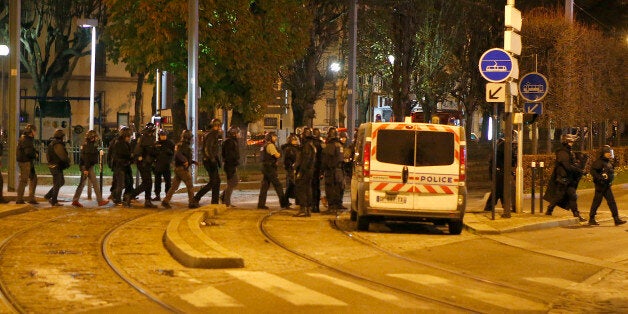 Police forces prepare in Paris, Wednesday, Nov. 18, 2015 after reports of a shooting in the northern suburb of St. Denis.(AP Photo/Francois Mori)