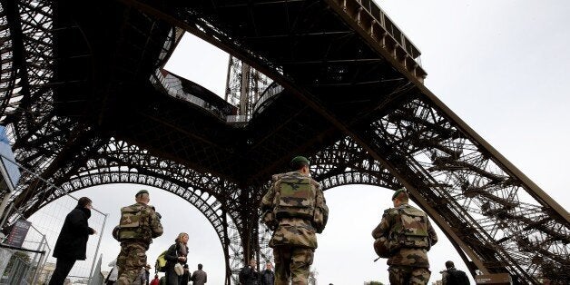 French soldiers patrol the area at the foot of the Eiffel Tower in Paris on November 14, 2015 following a series of coordinated attacks in and around Paris late Friday which left more than 120 people dead. French President Francois Hollande blamed the Islamic State group for the attacks in Paris that left at least 128 dead, calling them an 'act of war'. The multiple attacks across the city late Friday were 'an act of war... committed by a terrorist army, the Islamic State, against France, against... what we are, a free country,' Hollande said. AFP PHOTO / FRANCOIS GUILLOT (Photo credit should read FRANCOIS GUILLOT/AFP/Getty Images)