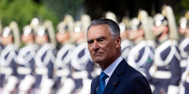 Portuguese President Anibal Cavaco Silva stands in front of a honor guard while waiting for the arrival of Senegal's President Macky Sall at the Belem presidential palace in Lisbon Tuesday, Sept. 8 2015. (AP Photo/Armando Franca)