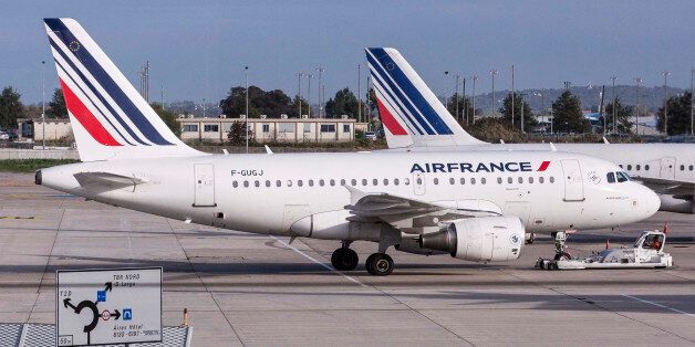 Air France passenger aircraft, operated by Air France-KLM Group, sit on the tarmac at Charles De Gaulle airport, operated by Aeroports de Paris, in Roissy, France, on Thursday, Oct. 8, 2015. Air France will bring in an aide to French Prime Minister Manuel Valls as human resources chief after the incumbent became embroiled in a tussle with protesters who ripped off his shirt at a briefing on job cuts. Photographer: Christophe Morin/Bloomberg via Getty Images