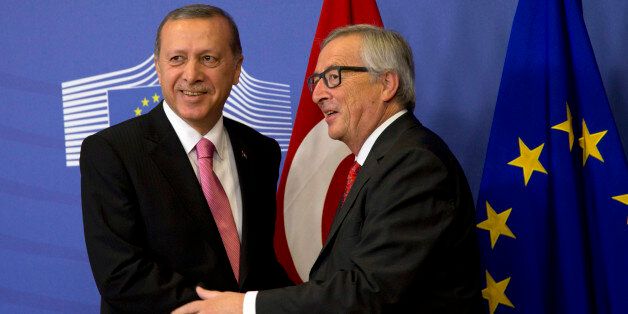 Turkish President Recep Tayyip Erdogan, left, is greeted by European Commission President Jean-Claude Juncker prior to a meeting at EU headquarters in Brussels on Monday, Oct. 5, 2015. Erdogan is on a two-day visit to meet Belgian and EU officials. (AP Photo/Virginia Mayo)