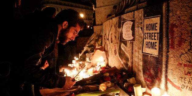 Mourners light candles at a Place de la RÃ©publique in Paris, France on Saturday, Nov. 14, 2015. French President Francois Hollande blamed Islamic State militants for coordinated strikes in Paris that left 127 dead, bringing the conflict with the radical group to the heart of the Western world. Photographer: Simon Dawson/Bloomberg via Getty Images