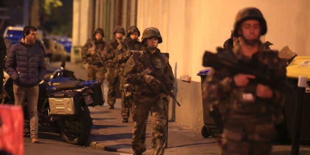French soldiers patrol in Paris suburb Saint Denis, Wednesday, Nov.18, 2015. Authorities are telling residents to stay inside during a large police operation near France's national stadium that two officials say is linked to last week's deadly attacks. (AP Photo/Thibault Camus)