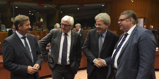 (L-R) Slovenia Foreign minister Karl Erjavec, German Foreign Minister Frank-Walter Steinmeier, Italian Foreign Affairs Minister Paolo Gentiloni and Finnish Foreign Minister Timo Soini talk with one another during a Foreign Affairs meeting at the European Union headquarters in Brussels on July 20, 2015. European foreign ministers meet to discuss the Iran nuclear deal, unrest in Libya and Tunisia and the deadlocked Middle East peace process. AFP PHOTO/JOHN THYS (Photo credit should read JOH