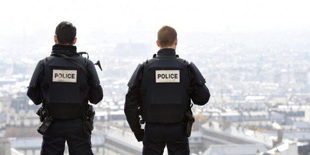 Police officers overlook Paris as they patrol in front of the Sacre Coeur Basilica on November 16, 2015, three days after a series of deadly oordinated attacks claimed by Islamic State jihadists, which killed at least 129 people and left more than 350 injured on November 13. AFP PHOTO/MIGUEL MEDINA (Photo credit should read MIGUEL MEDINA/AFP/Getty Images)