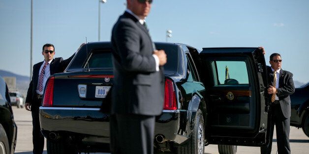 Secret Service agents stand around a presidential limo as President Barack Obama arrives at McCarran International Airport in Las Vegas, Monday, Aug. 24, 2015, to give remarks at the National Clean Energy Summit. (AP Photo/Andrew Harnik)