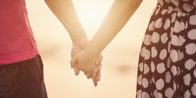 Young couple holding hands.