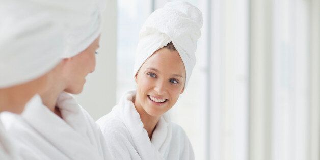 Women in bathrobes and hair wrapped in towels at spa