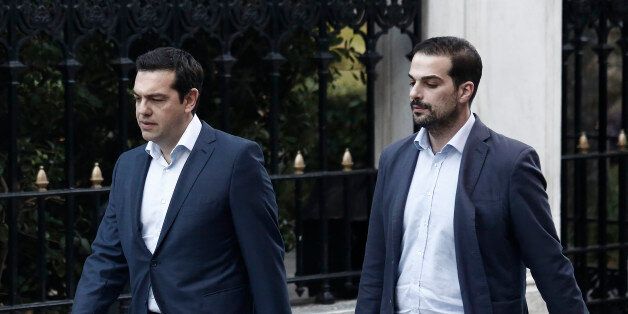 Alexis Tsipras, Greece's prime minister, left, and government spokesman Gabriel Sakelaridis, walk to Maximos mansion in Athens, Greece, on Monday, July 6, 2015. Euclid Tsakalotos was named finance minister to replace Yanis Varoufakis, who resigned Monday after more than five months of fruitless back and forth. Photographer: Kostas Tsironis/Bloomberg via Getty Images