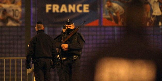 Police officers stand guard outside the Stade de France stadium after an explosion and after international friendly soccer match France against Germany, in Saint Denis, outside Paris, early Saturday Nov. 14, 2015. Multiple fatal attacks throughout the city have prompted President Francois Hollande to announce he was closing the country's borders and declaring a state of emergency. (AP Photo/Michel Spingler)
