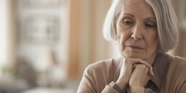 Senior Caucasian woman with chin in hands