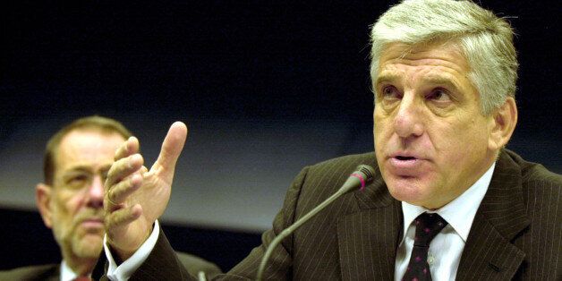Greek Defense Minister Yannos Papantoniou, right, gestures while speaking during a media conference after a meeting of EU foreign and defense ministers at the European Council building in Brussels, Tuesday Nov. 19, 2002. European Union defense ministers said Tuesday they hoped a special peacekeeping force of 60,000 would be up and running by next summer and ready to take on peacekeeping and humanitarian missions. Seated left is EU foreign policy chief Javier Solana. (AP Photo/Virginia Mayo)