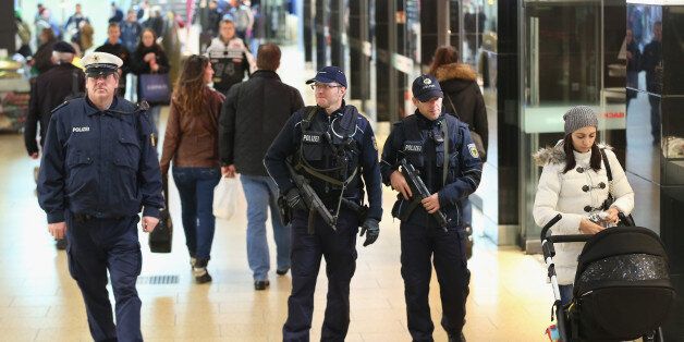 HANOVER, GERMANY - NOVEMBER 18: Heavily-armed German policemen patrol through a shopping passage inside Hauptbahnhof main railway station the day after the Germany vs. Netherlands friendly football match was cancelled due to a terror warning on November 18, 2015 in Hanover, Germany. German authorities cancelled the game two hours before it was due to start following what the German Minister of Interior said were concrete warnings from a foreign intelligence service that an attack was imminent. Investigators however found no explosives and made no arrests. (Photo by Sean Gallup/Getty Images)
