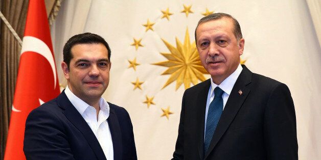 Greece's Prime Minister Alexis Tsipras, left, and Turkish President Recep Tayyip Erdogan shake hands before a meeting in Ankara, Turkey, Wednesday, Nov. 18, 2015. Turkey and Greece have agreed to cooperate to prevent the