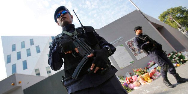 Thai police officers stand guard outside French Embassy in Bangkok, Thailand Thursday, Nov. 19, 2015 following last week's attacks in Paris. (AP Photo/Sakchai Lalit)
