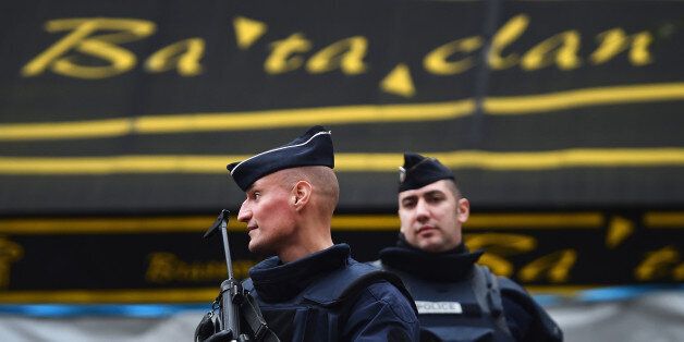 PARIS, FRANCE - NOVEMBER 16: A French police officers stand guard in front of the main entrance of Bataclan concert following Friday's terrorist attacks on November 16, 2015 in Paris, France. A Europe-wide one-minute silence was held at 12pm CET today in honour of at least 129 people who were killed last Friday in a series of terror attacks in the French capital. (Photo by Jeff J Mitchell/Getty Images)