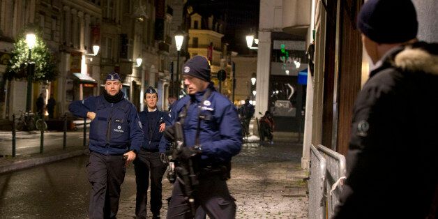 Police patrol during an operation in the center of Brussels on Sunday, Nov. 22, 2015. Western leaders stepped up the rhetoric against the Islamic State group on Sunday as residents of the Belgian capital awoke to largely empty streets and the city entered its second day under the highest threat level. With a menace of Paris-style attacks against Brussels and a missing suspect in the deadly Nov. 13 attacks in France last spotted crossing into Belgium, the city kept subways and underground trams closed for a second day. (AP Photo/Virginia Mayo)