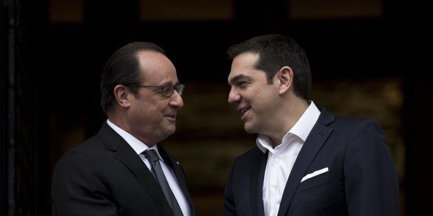 Greek Prime minister Alexis Tsipras, right, welcomes French President Francois Hollande, at Maximos mansion before their meeting in Athens, Friday, Oct. 23, 2015. Hollande called Thursday for talks relieving Greece's crushing debt load and spurring investment, measures that could help the country recover as it imposes harsh austerity measures demanded by international creditors.(AP Photo/Petros Giannakouris)