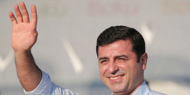 Selahattin Demirtas, leader of the pro Kurdish Democratic Party of Peoples (HDP) waves to people gathered for a pro-peace rally in Istanbul, Sunday, Aug. 9, 2015, against the outbreak of new clashes between Turkish security forces and pro-Kurdish rebels. Violence in Turkey has flared in recent weeks, shattering an already fragile peace process between the Kurdistan Workers' Party, or PKK, and the government. (AP Photo/Lefteris Pitarakis)