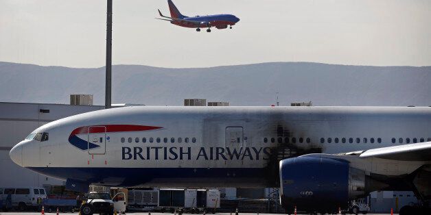 A damaged British Airways Boeing 777-200 sits at McCarran International Airport Wednesday, Sept. 9, 2015, in Las Vegas. An engine caught fire before takeoff Tuesday forcing the evacuation of the crew and passengers. (AP Photo/John Locher)