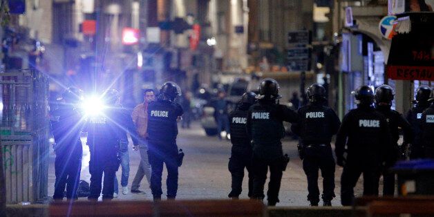 Police forces prepare in St. Denis, a northern suburb of Paris, Wednesday, Nov. 18, 2015. Authorities in the Paris suburb of St. Denis are telling residents to stay inside during a large police operation near France's national stadium that two officials say is linked to last week's deadly attacks. (AP Photo/Christophe Ena)