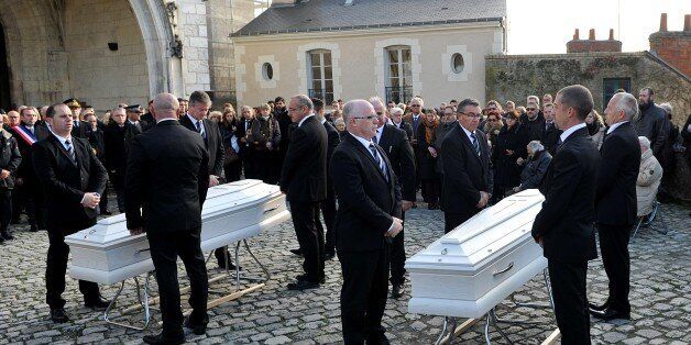 Friends and relatives of victims of the Paris terror attack claimed by the Islamic State group (IS) , Anna and Marion Petard-Lieffrig assemble before the coffins of the two sisters outside the the Saint Louis Cathedral in Blois, central France, on November 23, 2015 before the start of the funeral ceremonies. Anna Petard, 26, and her sister Marion, 30, were killed in the restaurant 'Le petit Cambodge' during the coordinated terror attacks claimed by the Islamic State group (IS) in Paris on Novem
