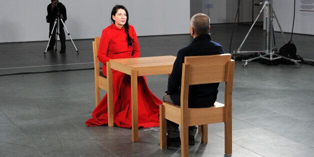 NEW YORK - MARCH 09: Artist Marina Abramovic (in red) performs during the 'Marina Abramovic: The Artist is Present' exhibition opening night party at The Museum of Modern Art on March 9, 2010 in New York City. (Photo by Andrew H. Walker/Getty Images)