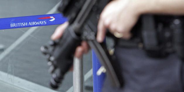 LONDON, United Kingdom: Armed British police patrol near the departures area of Terminal 4 at London's Heathrow airport, in south-east England, 14 August 2006. British and US authorities eased curbs for airline passengers Monday as Britain lowered its terror alert, deeming the threat of attack to be no longer imminent though still 'highly likely.' However, officials at Heathrow and Gatwick, the main airports serving the capital London, reported further flight cancelations and delays as security measures remained tight, albeit less stringent, for a fifth day. AFP PHOTO/LEON NEAL (Photo credit should read Leon Neal/AFP/Getty Images)