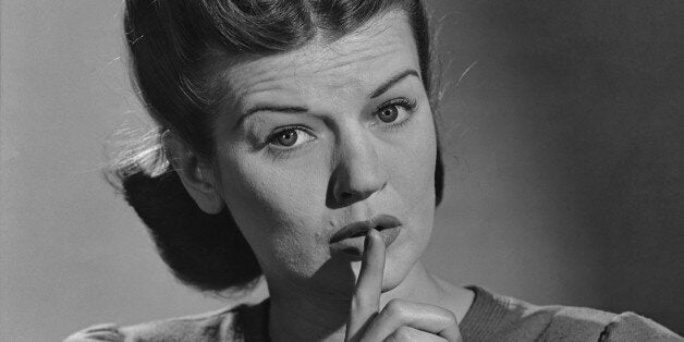 A woman signalling quiet, with her finger up to her lips, in the 1940's. (Photo by Keystone View/FPG/Getty Images)