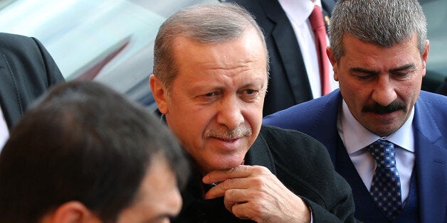 Turkey's President Recep Tayyip Erdogan, center, escorted by his bodyguards heading to his car outside a polling station, in Istanbul, Sunday, Nov. 1, 2015. Turkey holds a parliamentary election Sunday, a redo of the June election in which the Justice and Development Party, or AKP, lost its majority after 13 years of single-party rule. The key question is whether the ruling party gets enough seats for an outright majority in parliament or whether they have to form a coalition with one or more other parties in order to govern. (AP Photo/Hussein Malla)