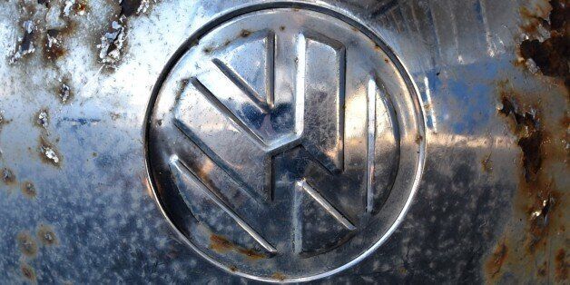 The logo of German car maker Volkswagen (VW) is seen on the wheel cap of a vintage VW beetle car at a workshop in Usseln, western Germany, on November 4, 2015. Shares in Volkswagen took a renewed battering as evidence emerged that the massive pollution cheating scandal engulfing the company may also involve petrol engines, not just diesel engines. AFP PHOTO / DPA / UWE ZUCCHI +++ GERMANY OUT +++ (Photo credit should read UWE ZUCCHI/AFP/Getty Images)