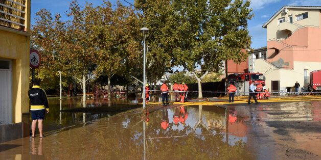 Emergency workers attended the scene where five residents were rescued and hospitalized after the rain engulfed a ground floor of the building next to the Sio River in the town of Agramunt, in Lerida province, Spain, Tuesday, Nov. 3, 2015. A river in northeastern Spain swelled by torrential downpours overflowed its banks early Tuesday morning, inundating a nursing home and killing four elderly residents, authorities said. (AP Photo/Santi Iglesias)