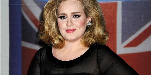 FILE - In this Feb. 21, 2012 file photo, performer Adele arrives for the Brit Awards 2012 at the O2 Arena in London. Adele is coming to the Golden Globes. The executive producer of the show says the 24-year-old Grammy-winning pop star is set to make her first post-baby appearance at the ceremony on Sunday, Jan. 13, 2013, where she is nominated for original song for the James Bond theme âSkyfall.â (AP Photo/Jonathan Short, File)