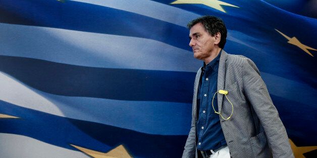 Euclid Tsakalotos, Greece's finance minister, walks towards the podium during a ministerial handover ceremony at the finance ministry in Athens, Greece, on Monday, July 20, 2015. German Chancellor Angela Merkel held out the prospect of limited debt relief as crisis-ravaged Greece prepares to reopen its banks three weeks after they were shut. Photographer: Yorgos Karahalis/Bloomberg via Getty Images