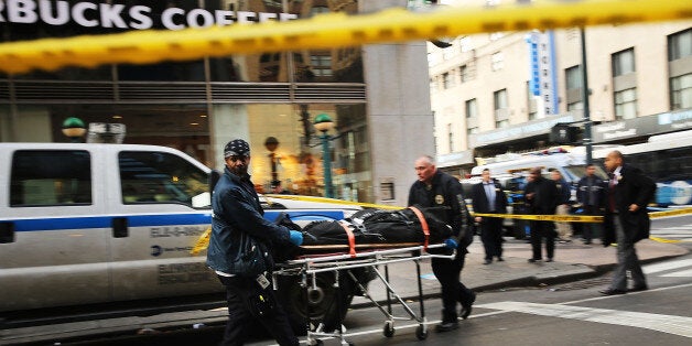 NEW YORK, NY - NOVEMBER 09: A body is brought up from a subway platform at the scene of a midtown shooting that left one dead with two others wounded on November 9, 2015 in New York City. A 43-year-old man was shot and killed in the morning shooting inside a subway station at Eighth Avenue and 35th Street in Manhattan, near Pennsylvania Station. Police are put up crime stoppers posters and are searching for the gunman and two other men. (Photo by Spencer Platt/Getty Images)