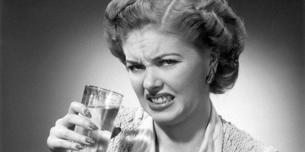 UNITED STATES - CIRCA 1950s: Woman drinking glass of water with look of disgust. (Photo by George Marks/Retrofile/Getty Images)