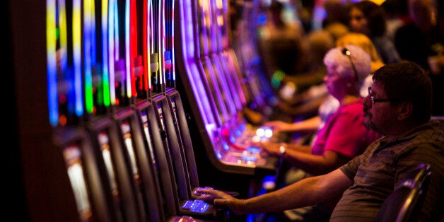 Guests play slot machines at Plainridge Park Casino in Plainville, Massachusetts, U.S., on Thursday, July 16, 2015. Plainridge Park Casino is the first casino to open in state of Massachusetts after many years of political debate and losing potential revenue to neighboring states. Photographer: Shiho Fukada/Bloomberg via Getty Images